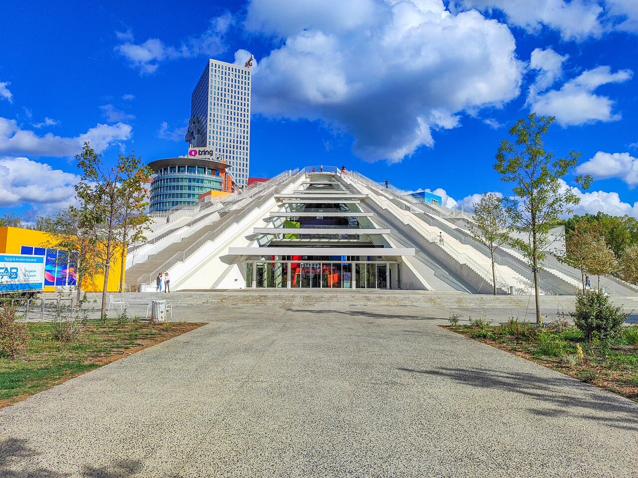 The Pyramid of Tirana approached from the plaza on a clear day.